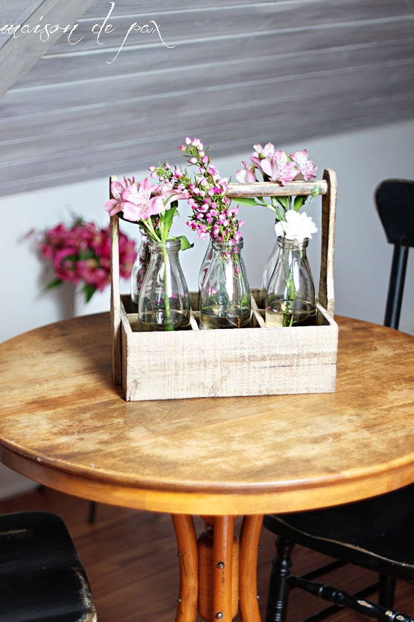 This stunning carrier made from reclaimed wood holds 6 antique milk bottles and makes the perfect rustic yet elegant piece of decor!