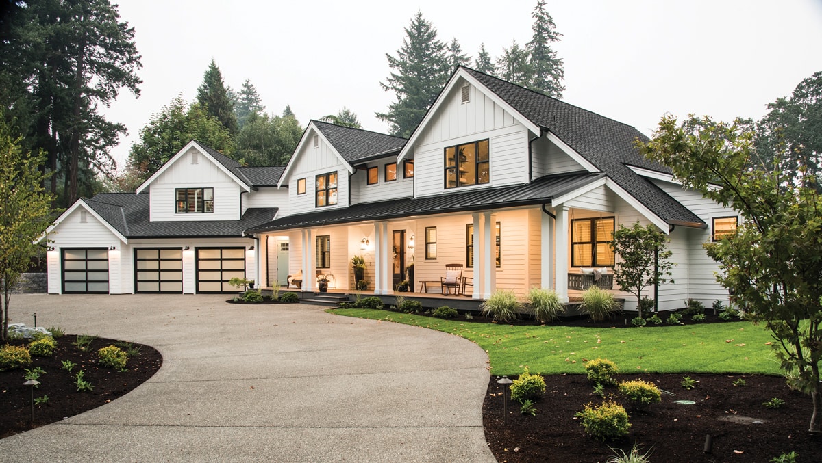 white house with black metal porch roof and black exterior windows | Maison de Pax