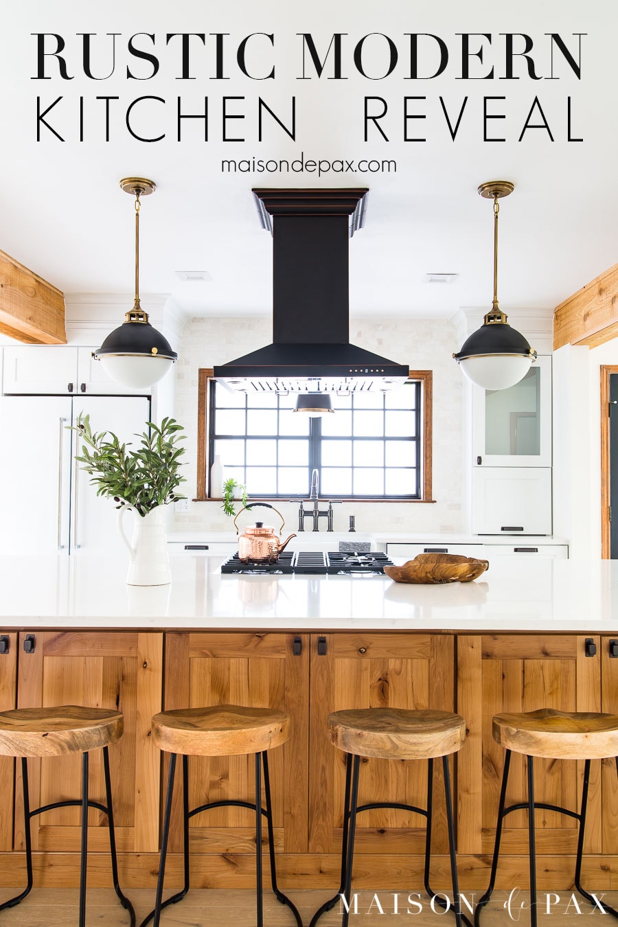 big wood island kitchen with white counters and black accents