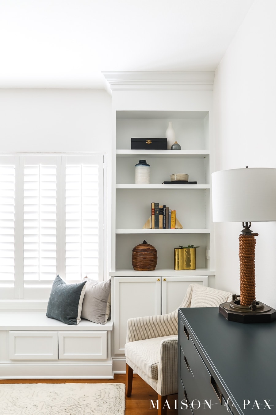 navy dresser with white built-in bookshelves