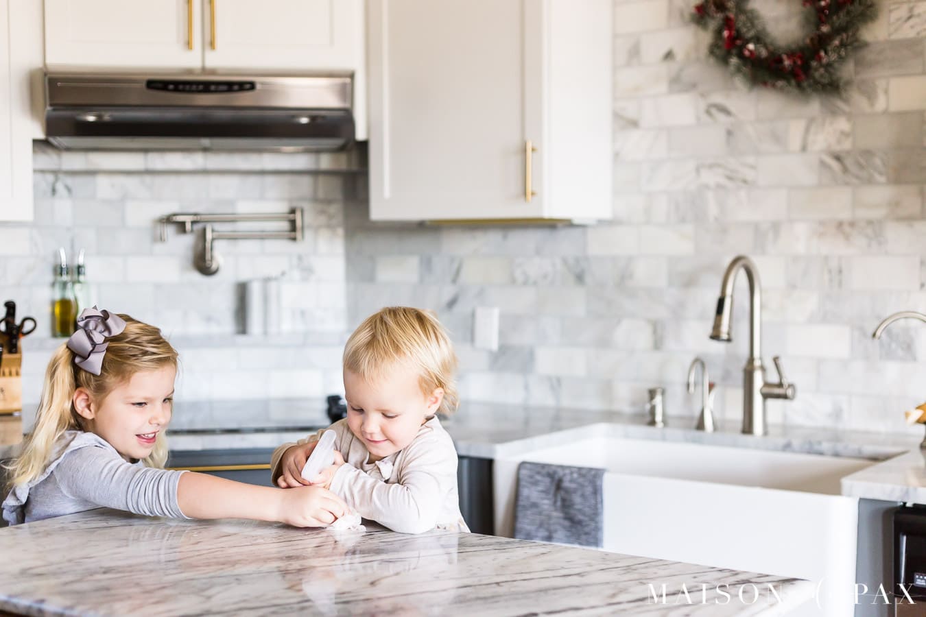girls cleaning marble kitchen island counter | Maison de Pax