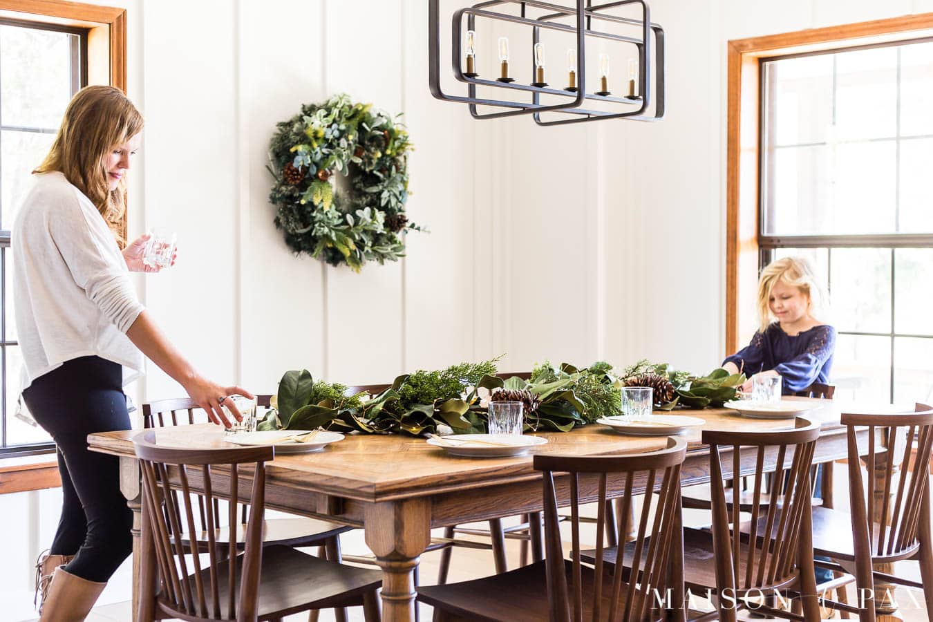 woman and girl setting Christmas table | Maison de Pax