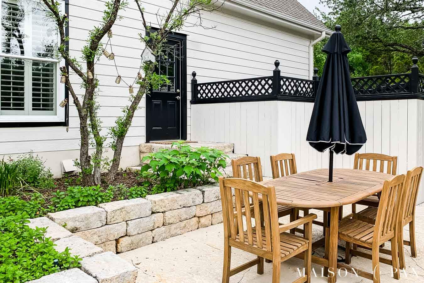 outdoor dining space black and white house teak furniture