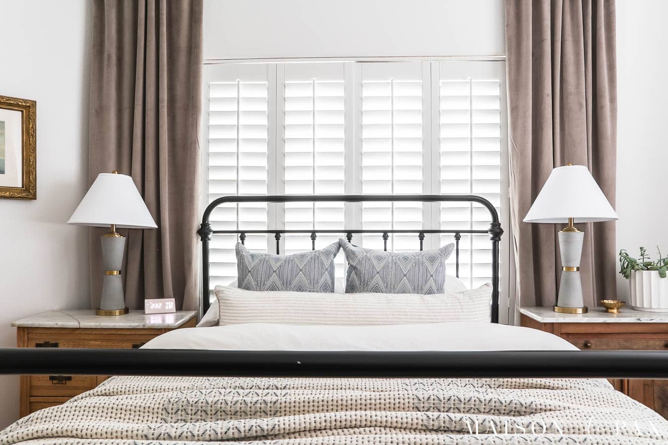 vintage iron bedframe, bed in front of window