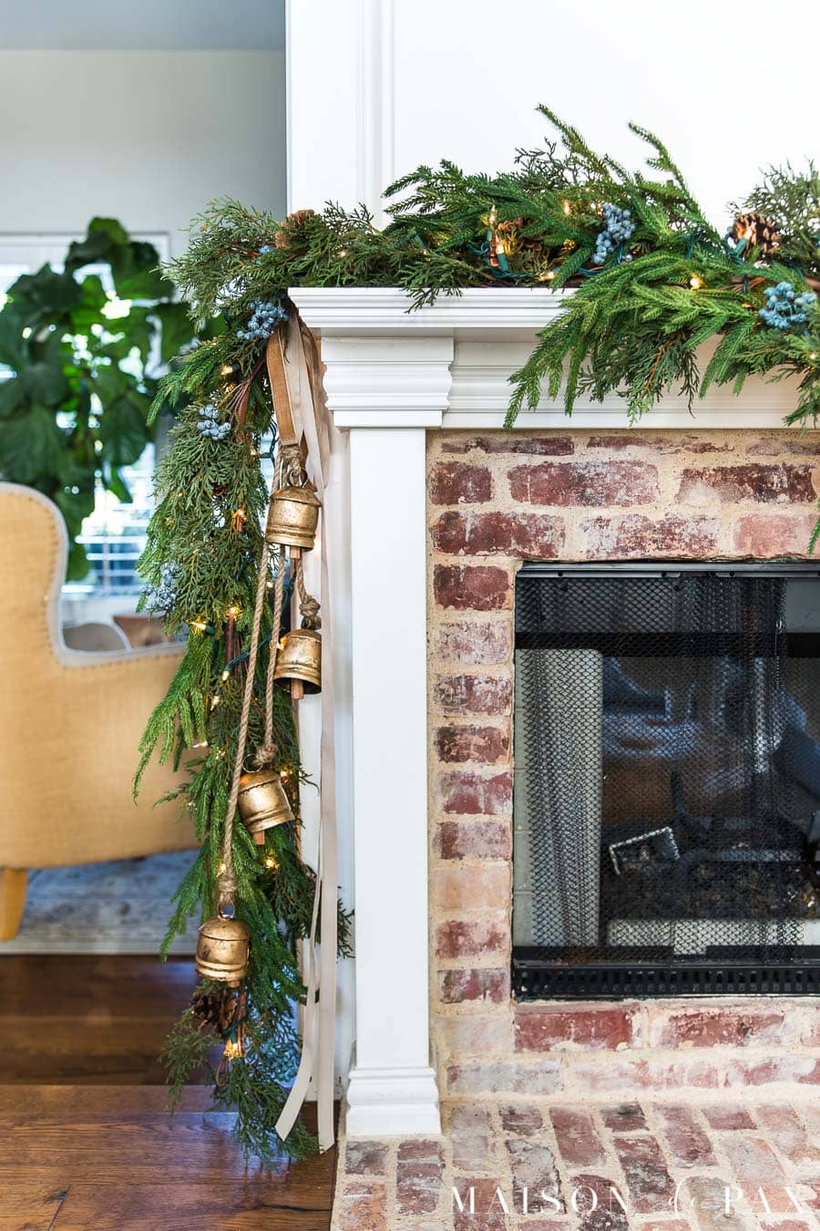 brass bells and velvet ribbon on holiday mantel