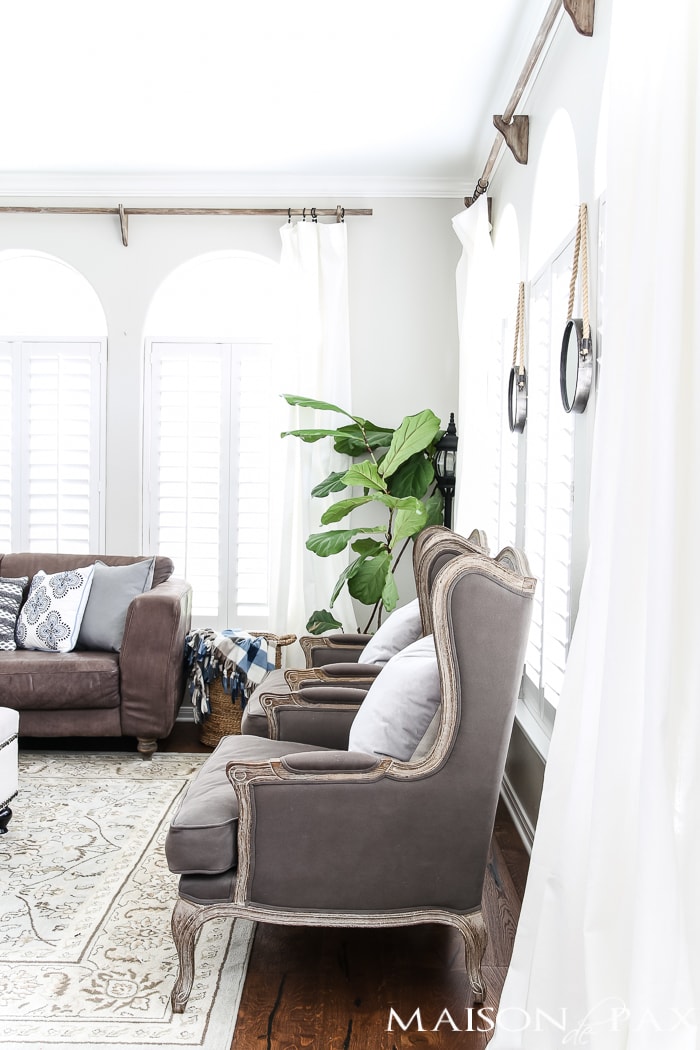 cozy throws and patterned pillows balance white curtains for a light yet comfy fall look #falldecor