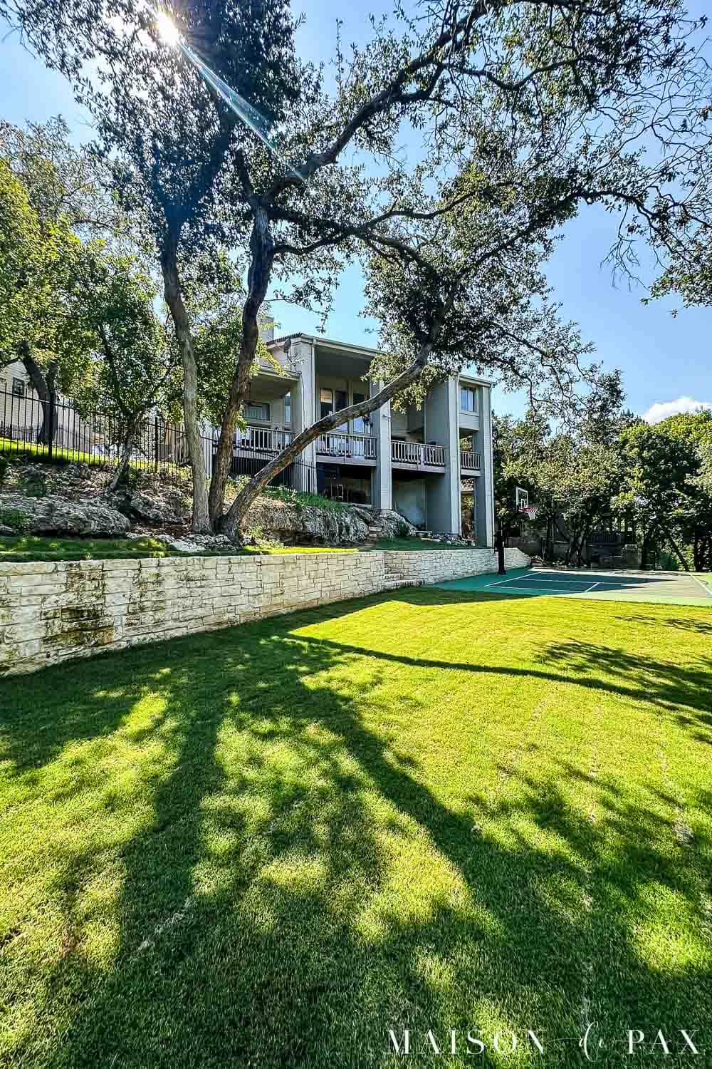 large backyard with trees and sport court