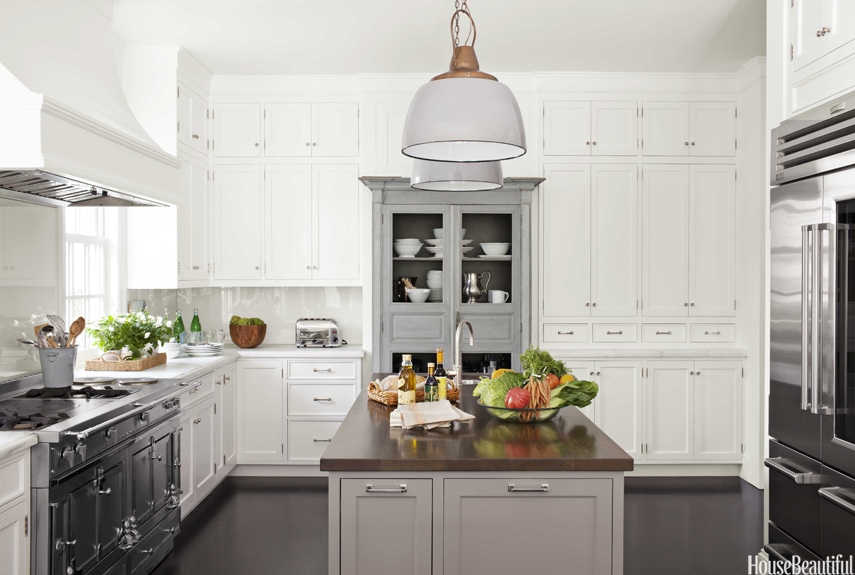 white kitchen with gray island and furniture style storage