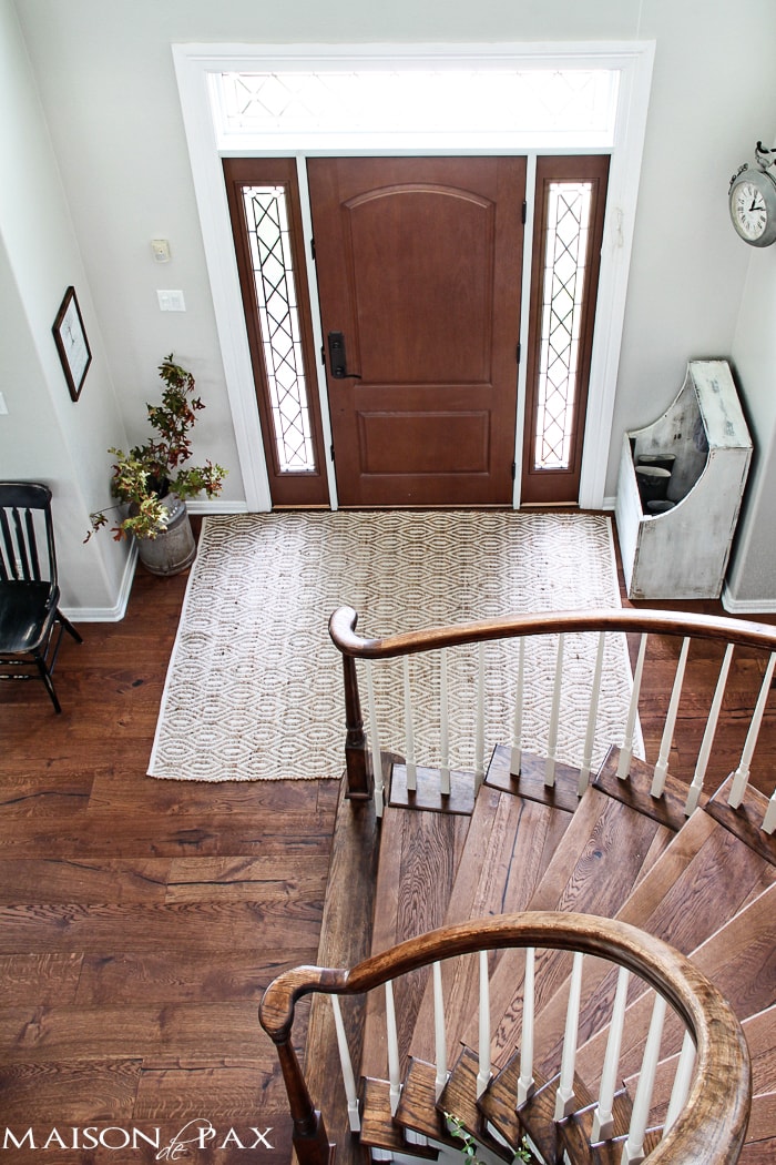 gorgeous stairwell and functional entryway with an antique wood firebox used as a mini mudroom | aiweb9ygdry.cmersite.com