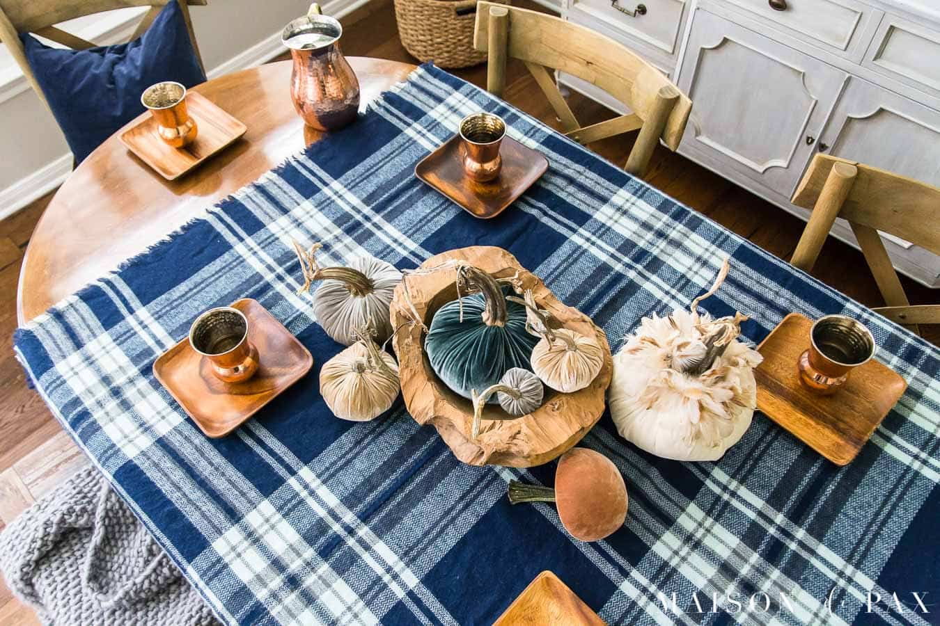 velvet pumpkin centerpiece with plaid tablecloth