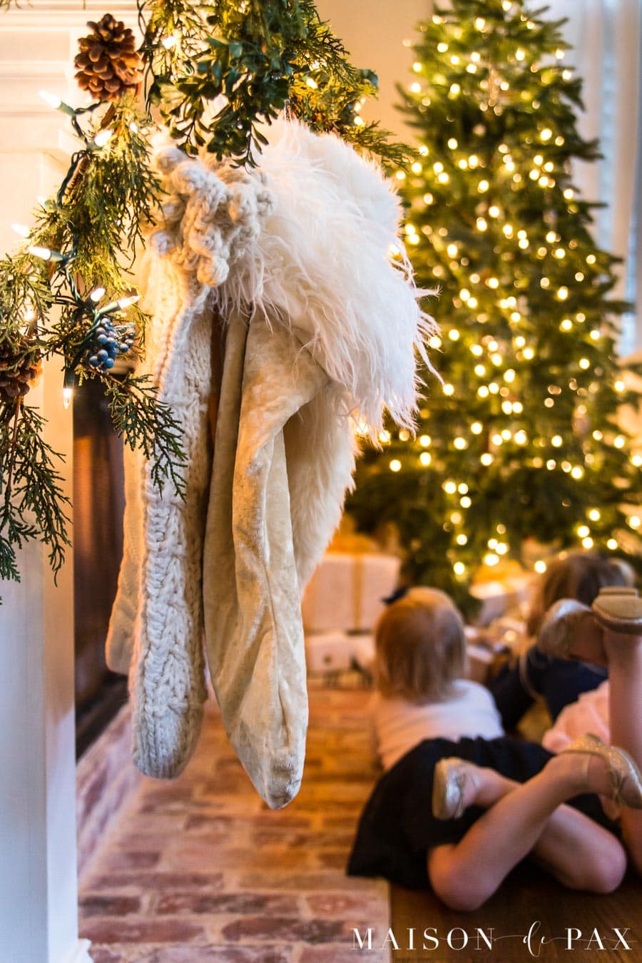 girls looking at Christmas lights on tree | Maison de Pax