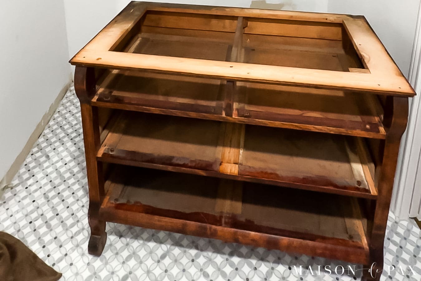 antique wood dresser with top removed for conversion into bathroom vanity with marble top