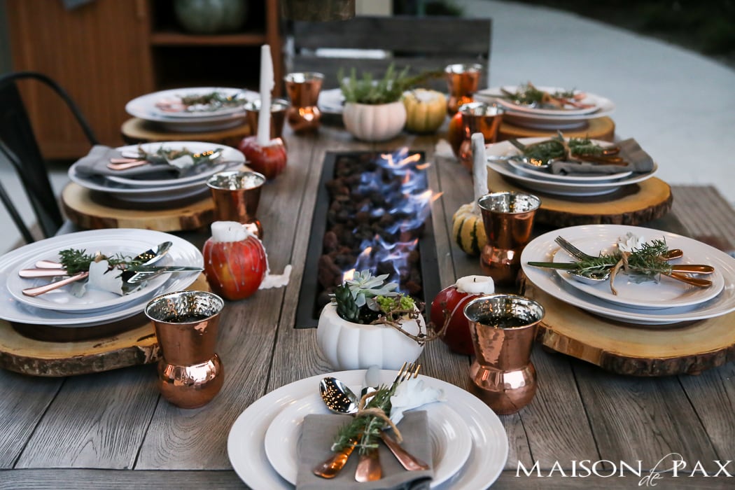 outdoor fall tablescape: lanterns, string lights, apple candles, and other cozy outdoor fall decorating ideas!