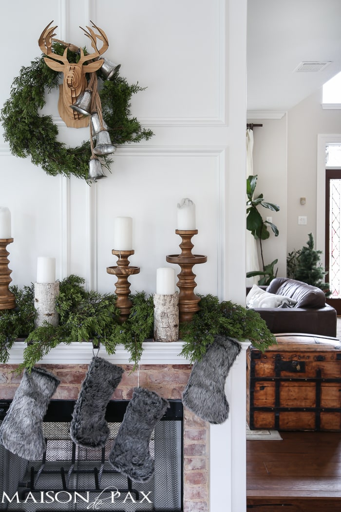Winter Woodland Christmas Mantel: Looking for mantel decorating ideas? Some fresh cut cedar, candlesticks, and a faux deer mount creates the perfect holiday decor.