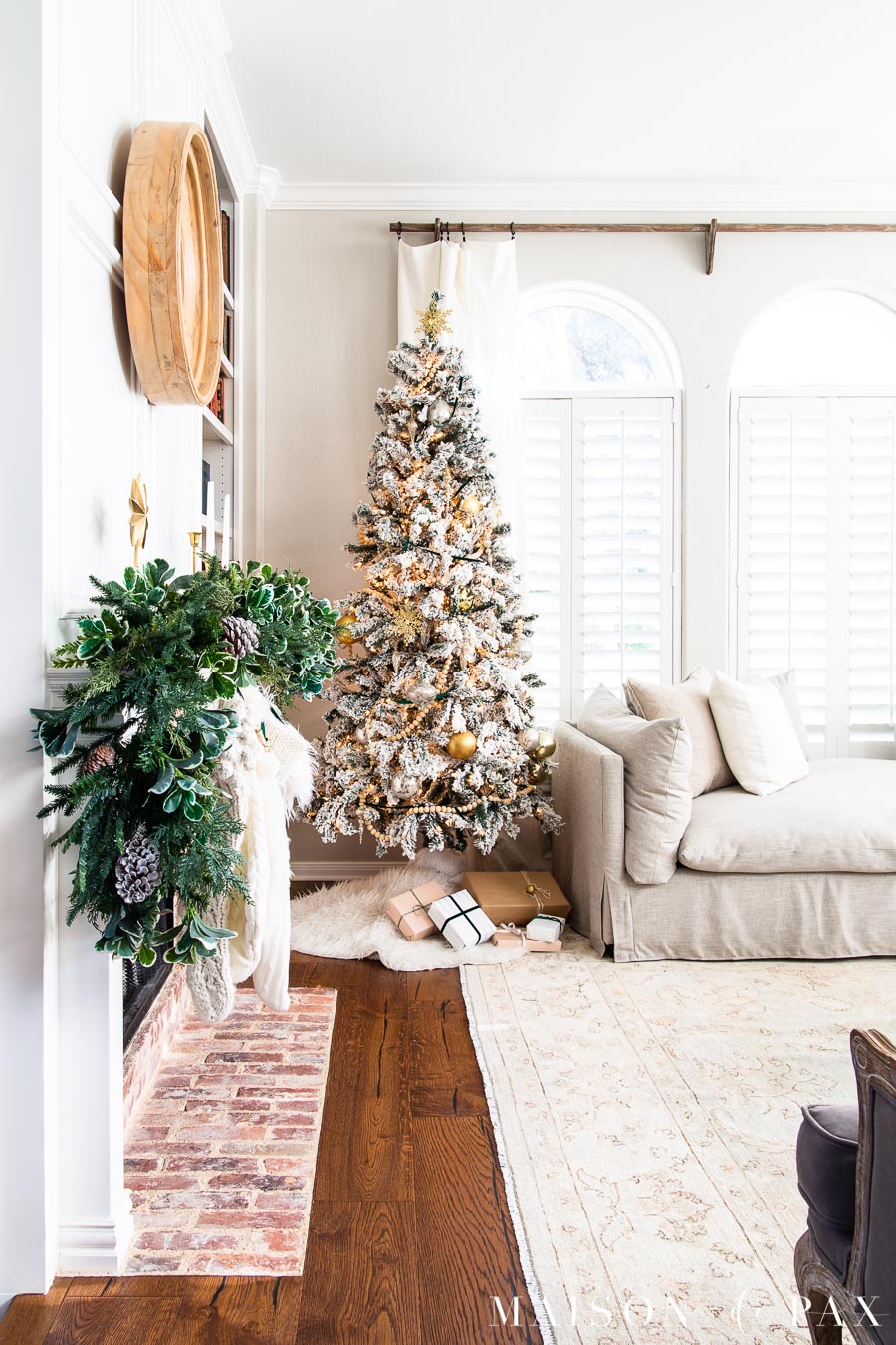flocked tree tucked beside neutral sofa | Maison de Pax