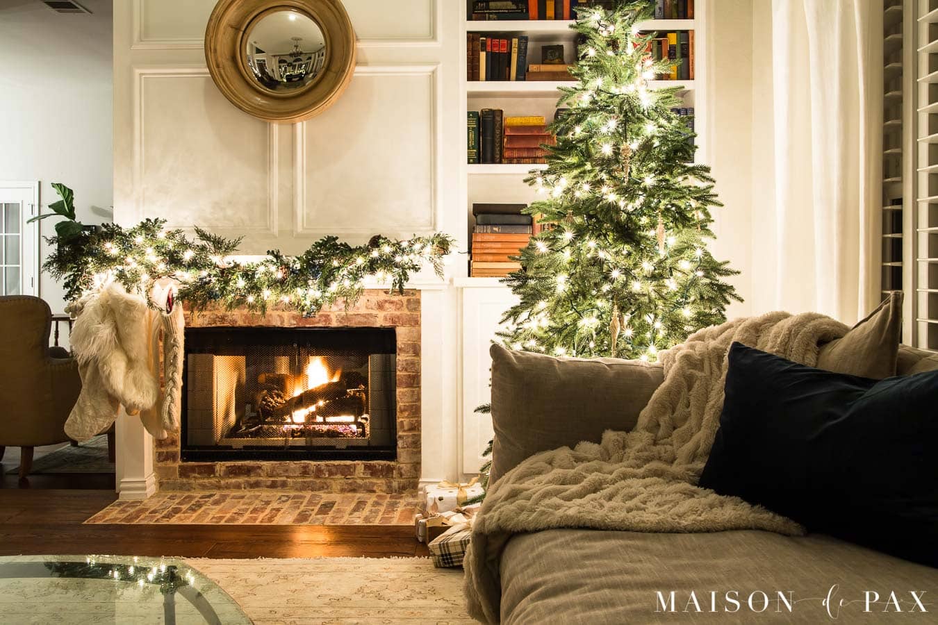 cozy couch beside christmas tree and fireplace | Maison de Pax