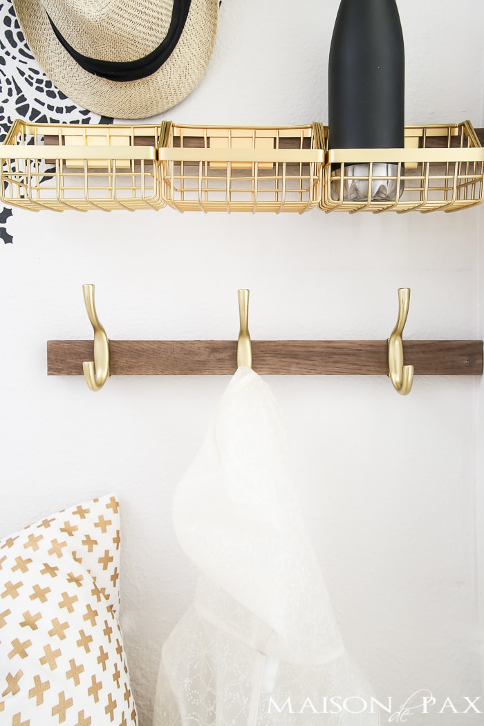 How to turn closet into mudroom: What an adorable space! Baskets and hooks turn a closet under the stairs into a functional mudroom space for a family.