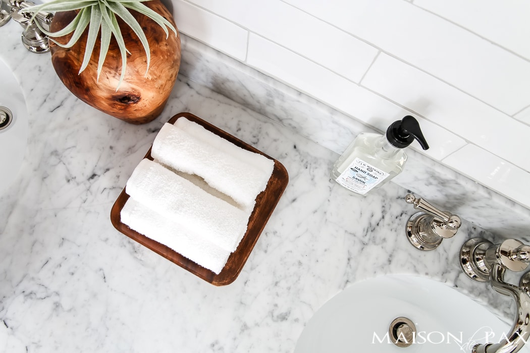 Navy and white bathroom with brass and wood accents: Find out where to find affordable sources for a bathroom remodel like this!