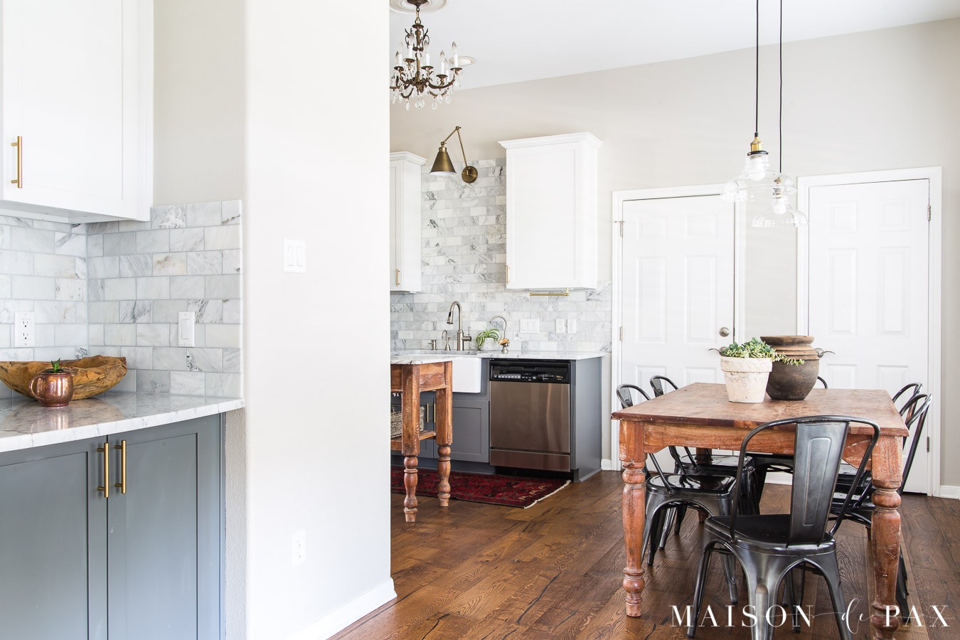 marble kitchen with wood island and table | Maison de Pax