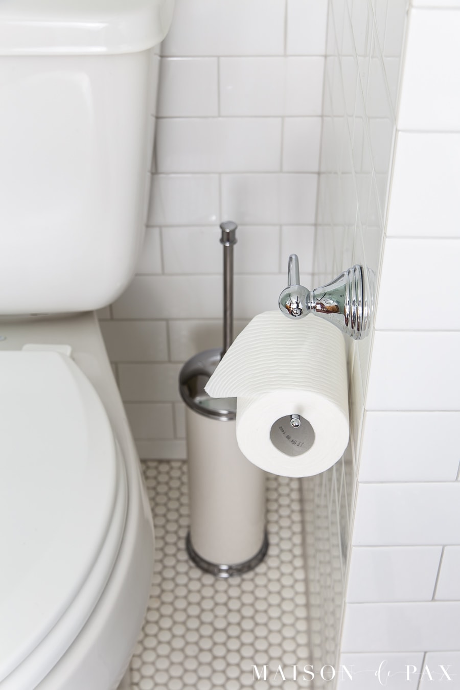 white subway wall tile, white penny floor tile and chrome accents