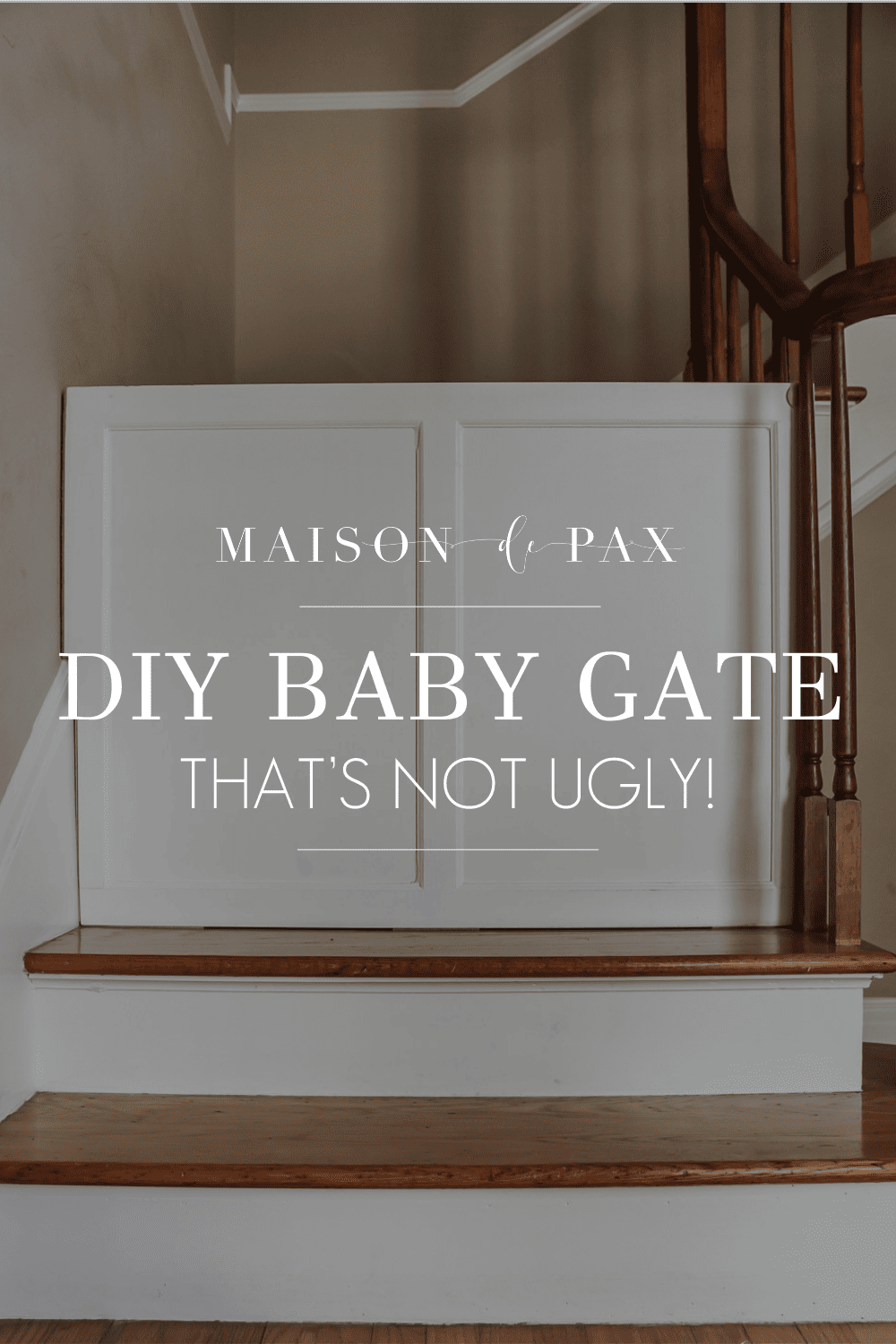 wooden gate at bottom of stairs with text overlay: diy baby gate that's not ugly