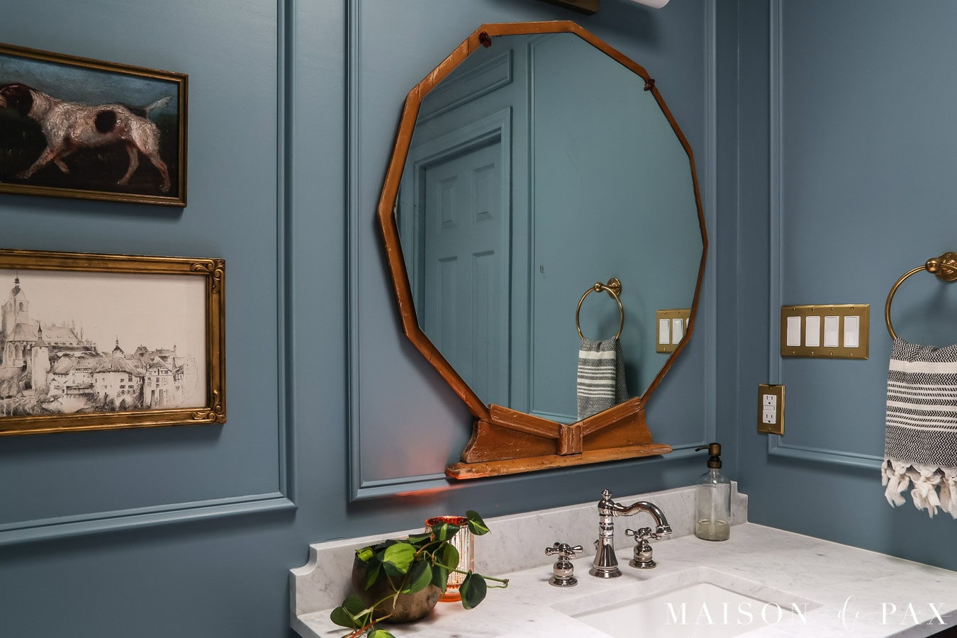 small blue gray bathroom with smooth walls and picture frame molding
