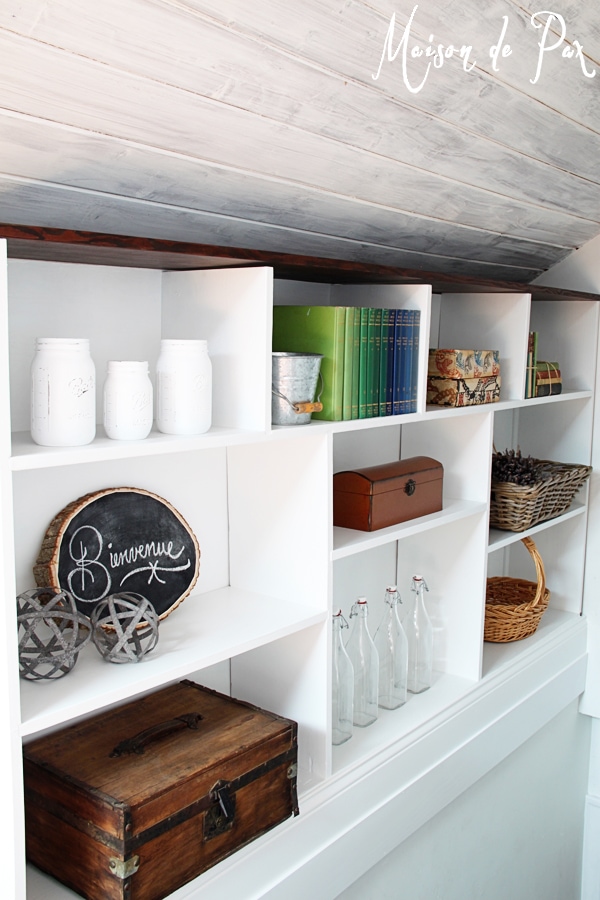 A DIY stairwell bookcase provides a creative and beautiful way to open the space and bring light into the stairwell.  Click through to see details and instructions!