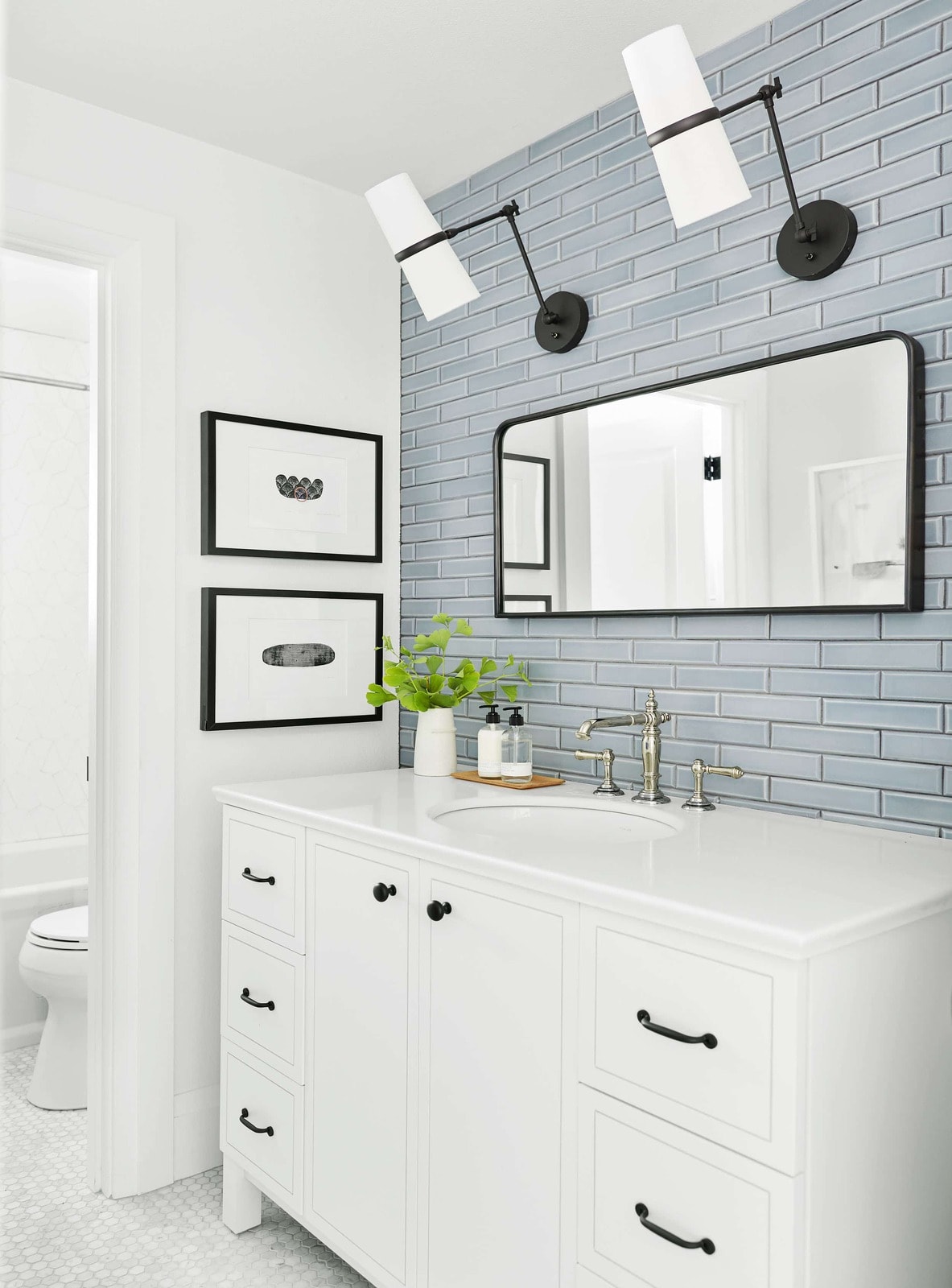 Modern farmhouse mixed metal bathroom with a black framed mirror and lighting with a polished nickel sink faucet- Maison de Pax