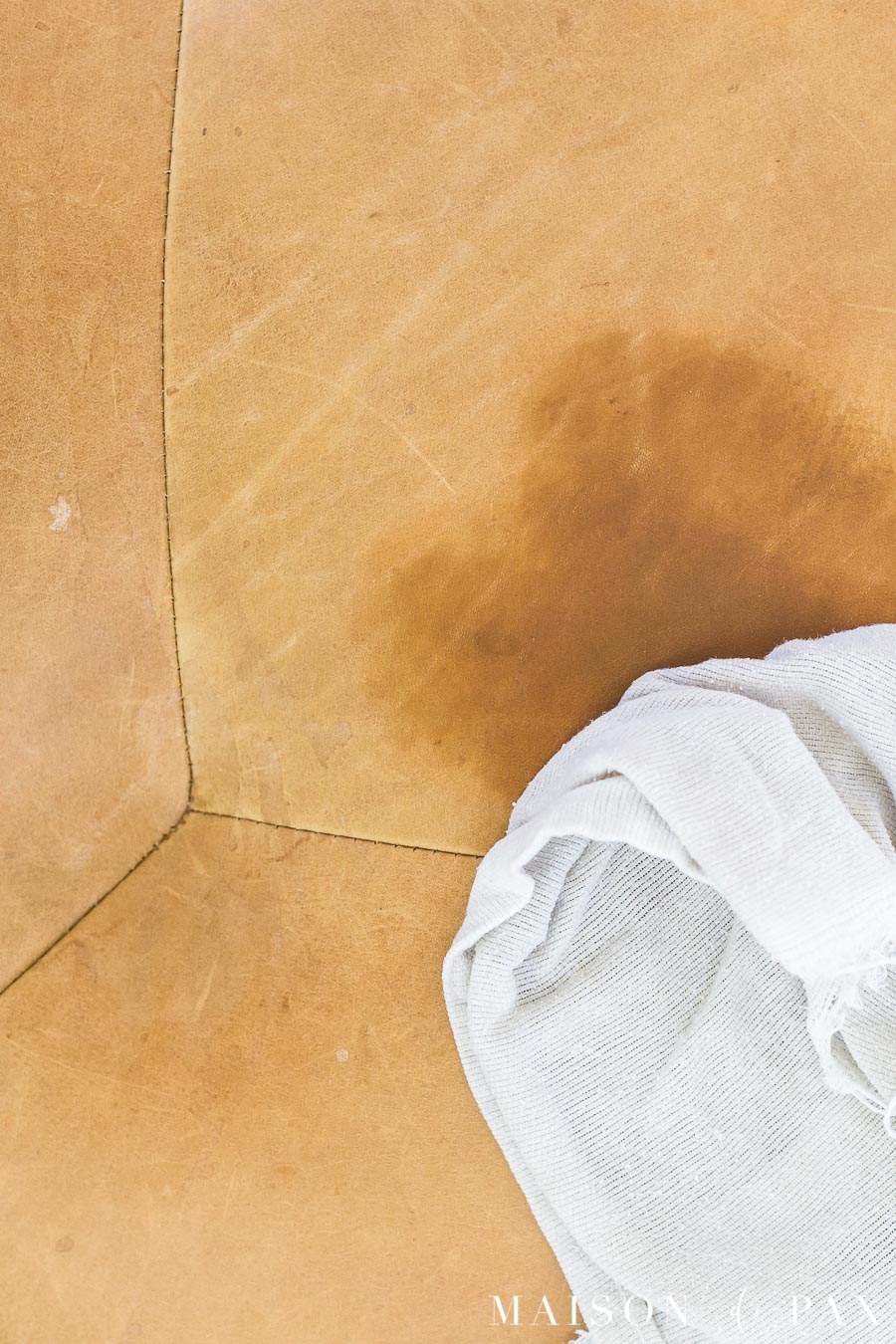 brown leather furniture with water spot and cleaning rag | Maison de Pax