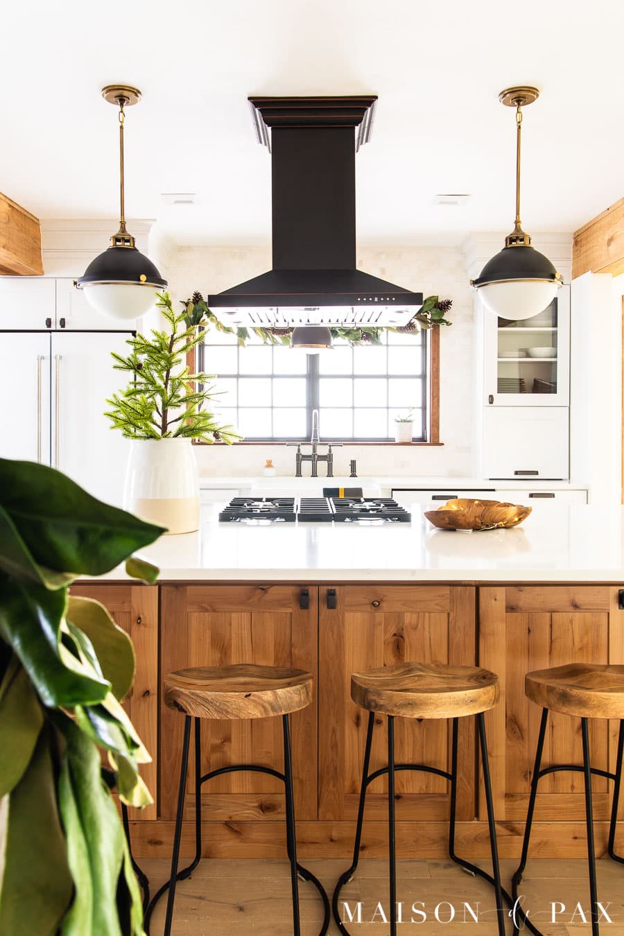 island with hood and black and white pendant lights | Maison de Pax