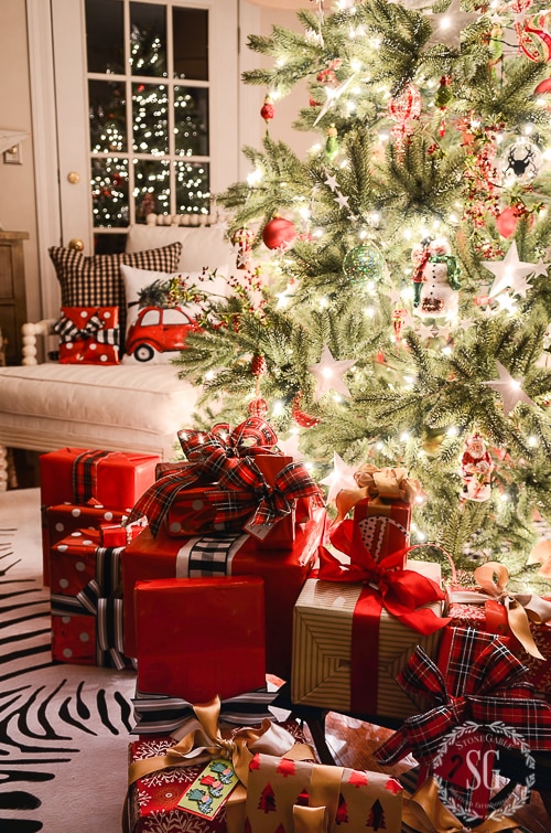 gorgeously wrapped gifts - what a cozy space by the tree!