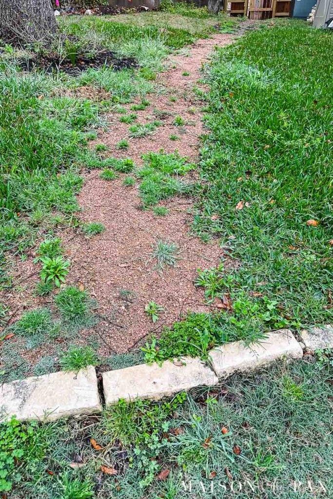 weeds overgrown onto granite path