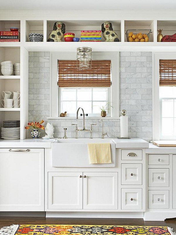 white kitchen with open shelves, farmhouse sink marble countertops and marble subway tile backsplash