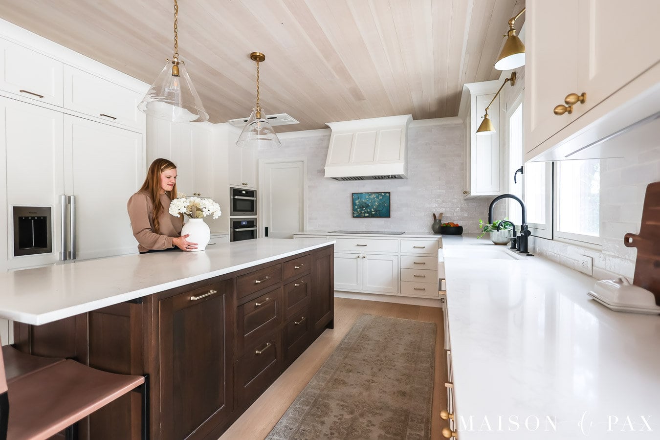 woman placing flowers on kitchen island