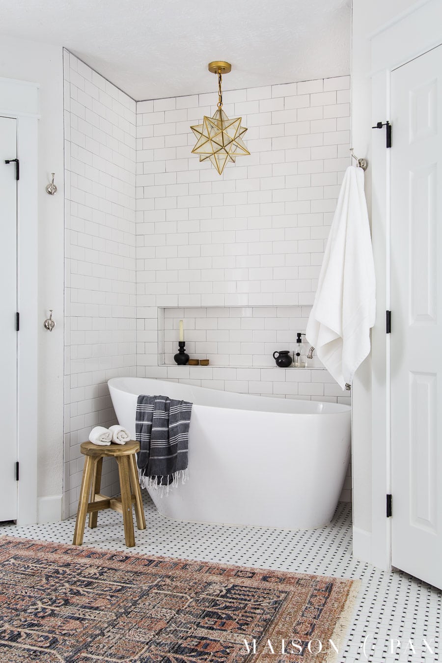 freestanding slipper tub in tiled nook with white subway tile