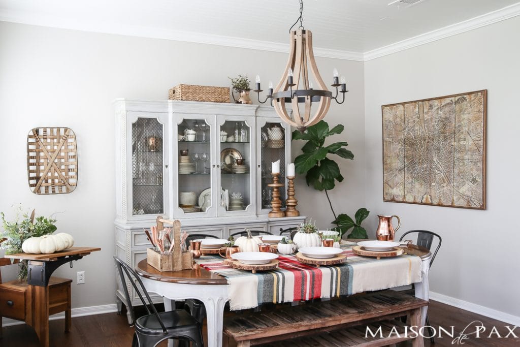 Be inspired to create a gorgeous, rustic Thanksgiving tablescape with these Thanksgiving decorating ideas! This table incorporates plaid, copper, and wood to create a beautiful yet relaxed look.