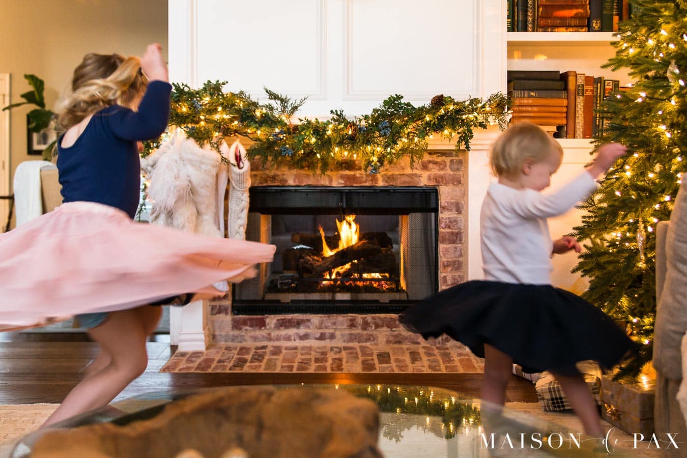 girls playing by Christmas tree | Maison de Pax