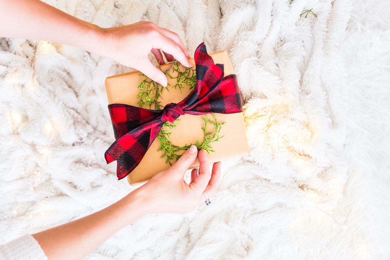 mini wreath on brown paper package with red buffalo ribbon | Maison de Pax