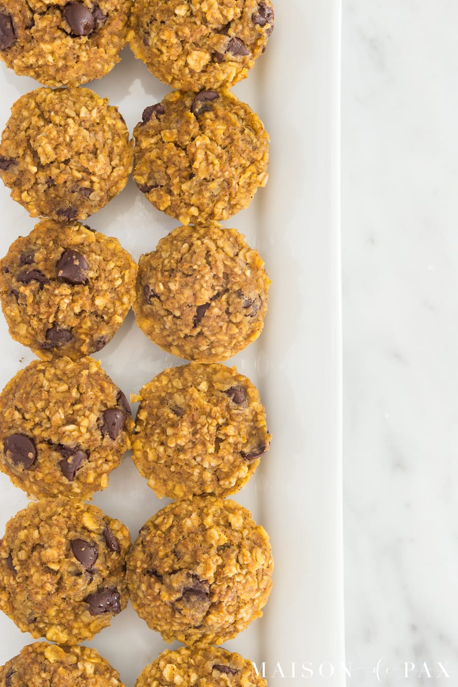 Gluten free pumpkin muffins with chocolate chips: Made with applesauce and a touch of maple syrup for sweetening, oat flour, and pumpkin, these are packed with delicious flavor and nutritious ingredients #gf #glutenfree #pumpkinspice #fallrecipe #pumpkinrecipe #pumpkinmuffins #breakfast #gfbreakfast 