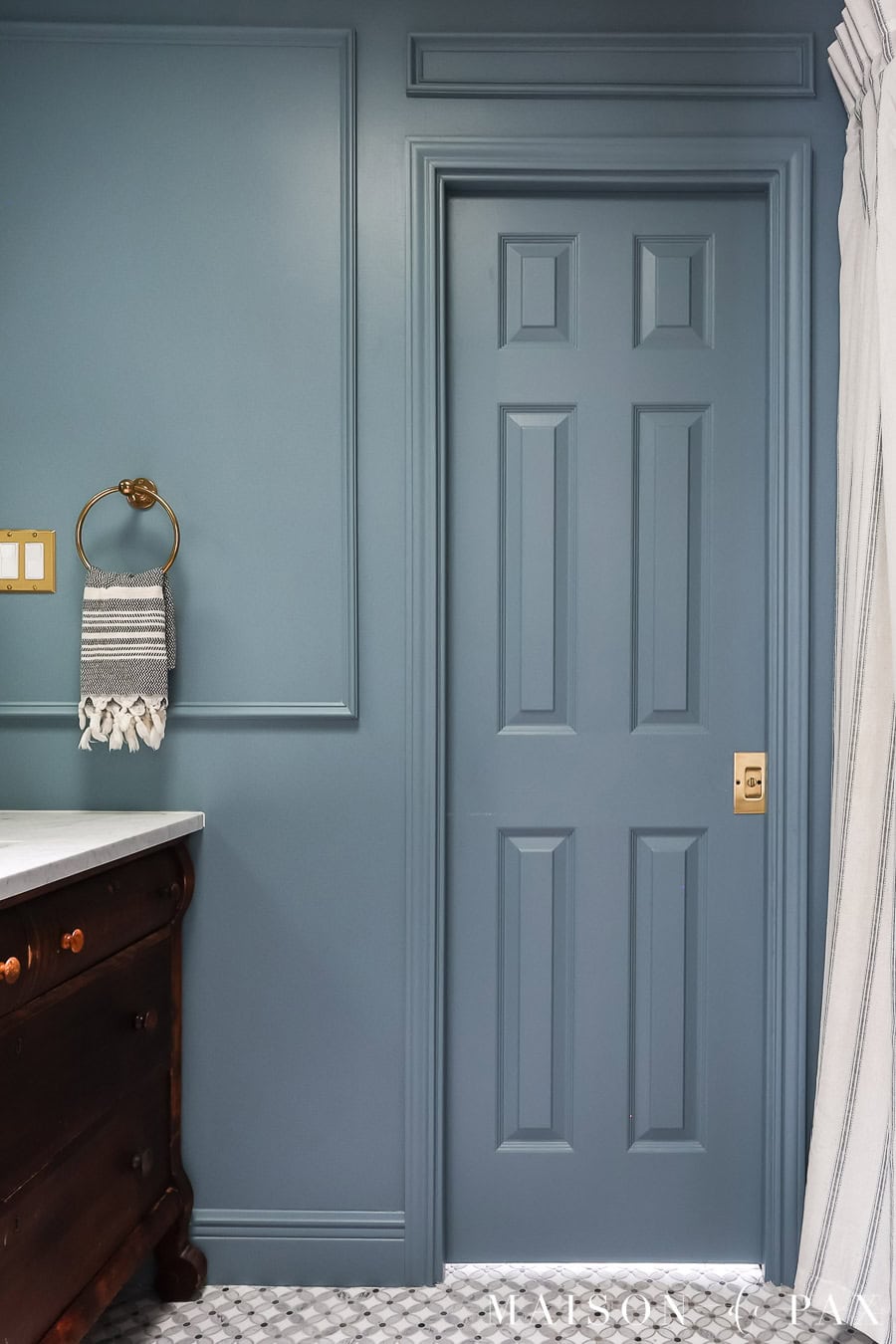 elegant small blue bathroom with wall mouldings