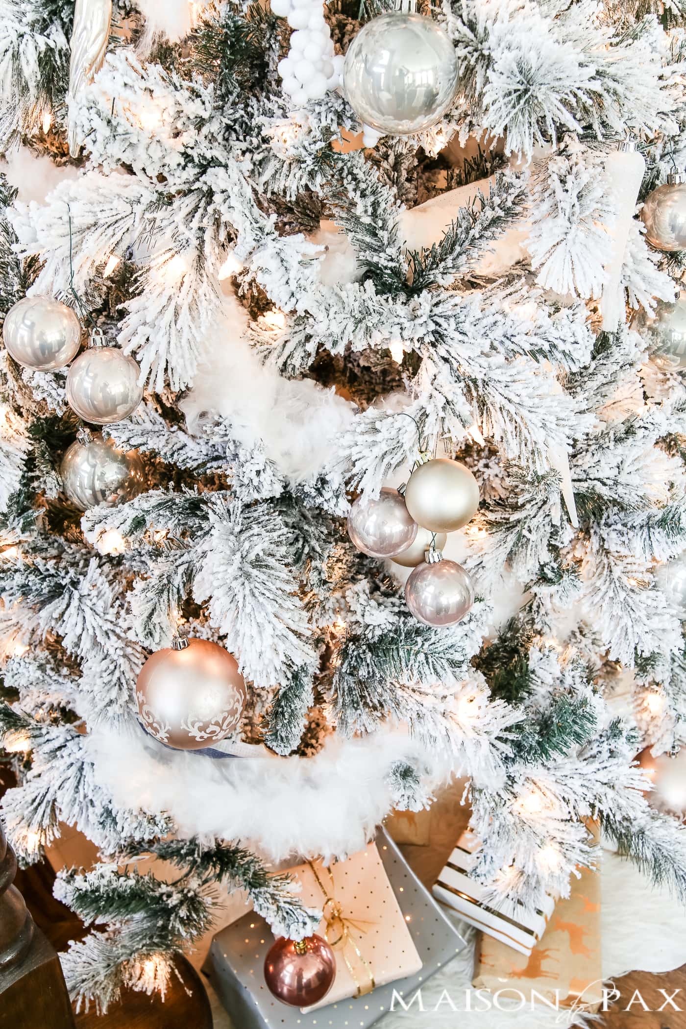 blush ornaments in groupings on a flocked tree #christmastree