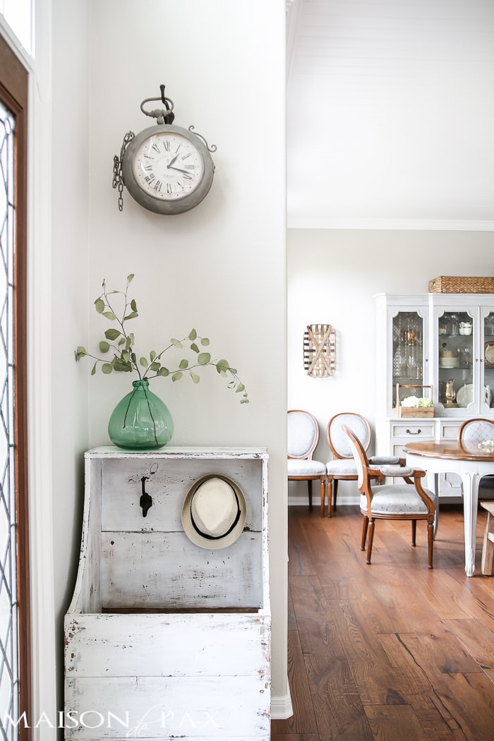Love the simple eucalyptus in a green glass demijohn! What a beautiful home with light touches of greenery perfect for spring or summer | aiweb9ygdry.cmersite.com