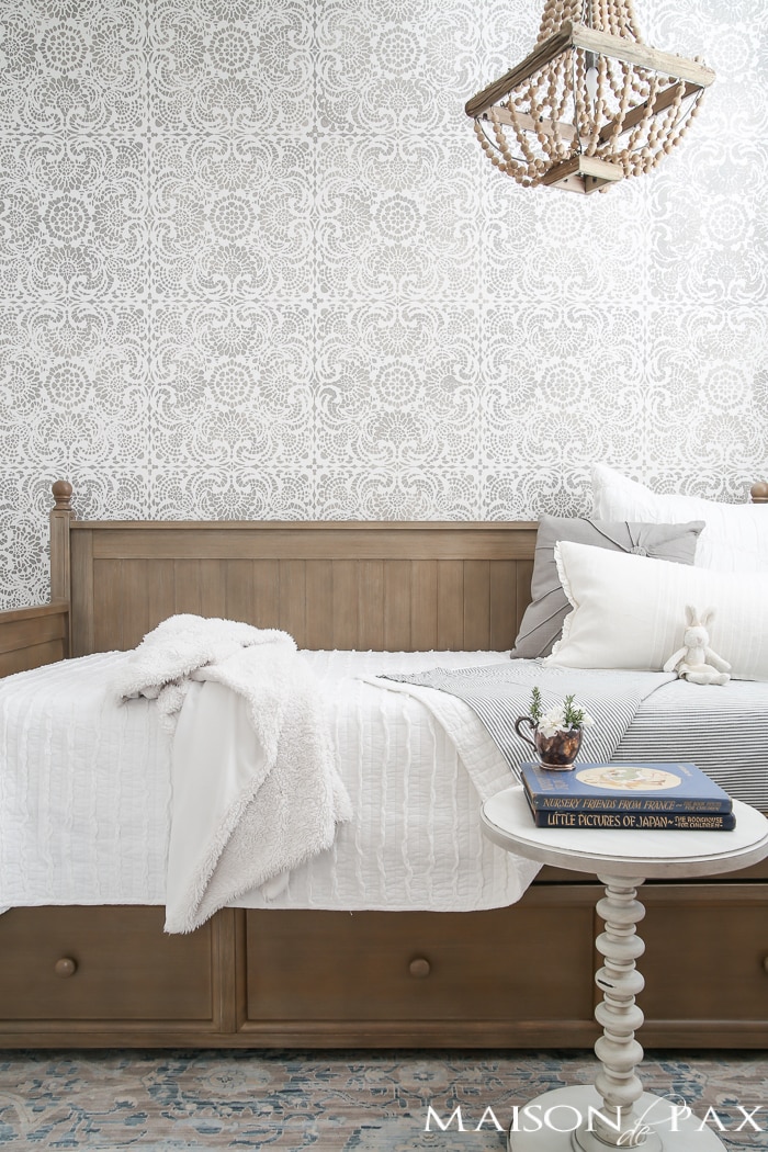 Elegant, neutral little girl room with wood tones and a stenciled accent wall: A gray-washed trundle bed provides the perfect anchor for a gorgeous, neutral yet feminine little girl's room.