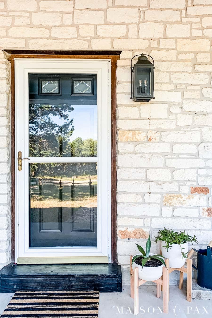 black door, black porch light, and striped doormat on modern farmhouse porch | Maison de Pax