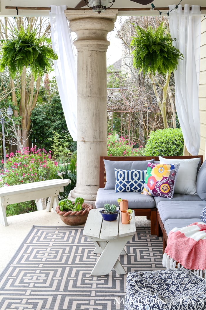 Boston ferns hung from concrete patio space- Maison de Pax