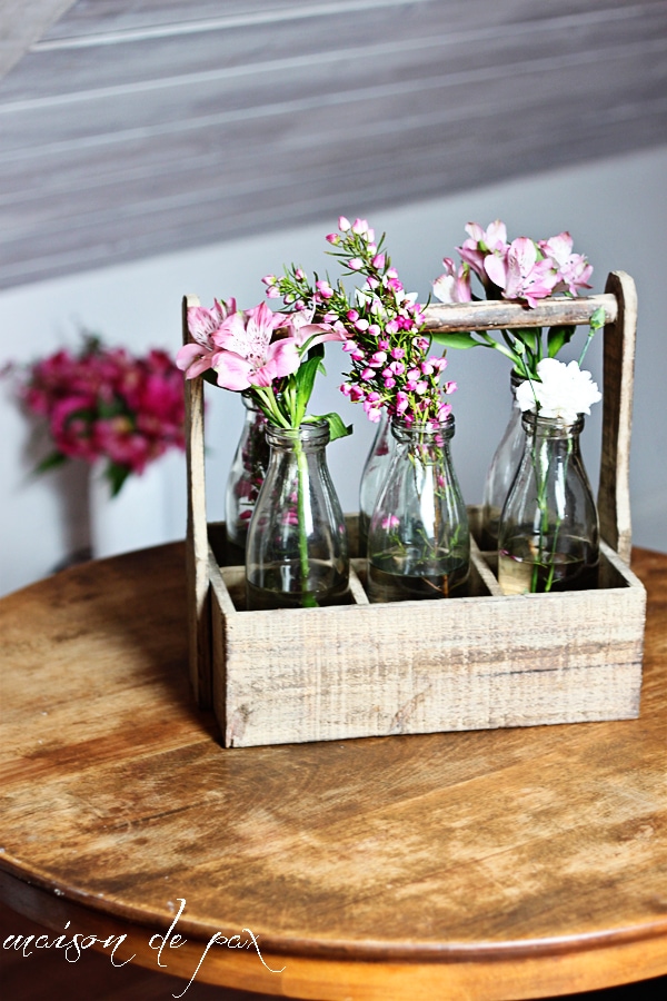 This stunning carrier made from reclaimed wood holds 6 antique milk bottles and makes the perfect rustic yet elegant piece of decor!