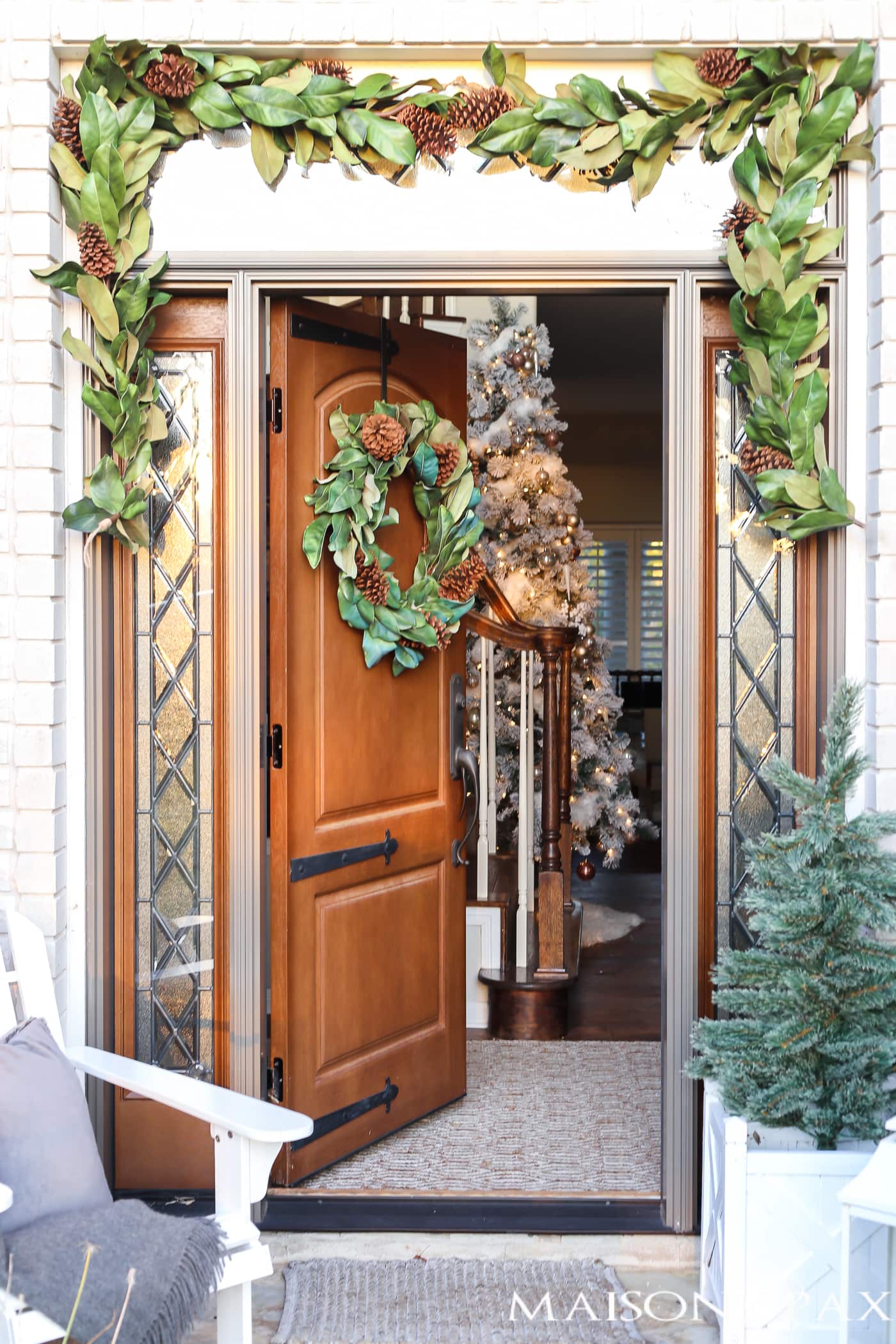 magnolia garland around the front door and magnolia wreath on the door - so southern and inviting #magnolia