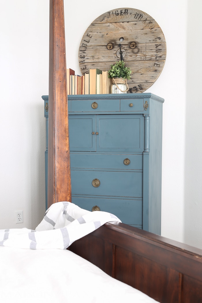 lovely soft yet deep blue antique dresser acts as an accent in this otherwise white bedroom | aiweb9ygdry.cmersite.com