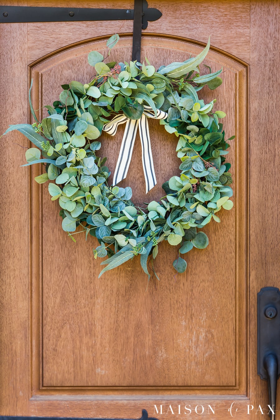 eucalyptus wreath on a wood front door | Maison de Pax