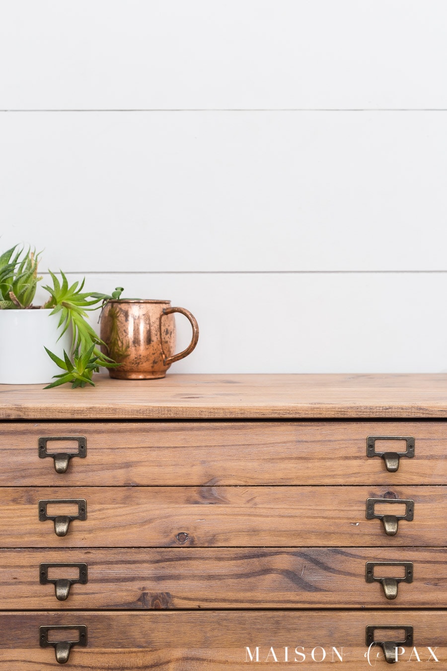 medium rustic wood, tiny drawers, and library pulls give a dresser an antique printer's cabinet look